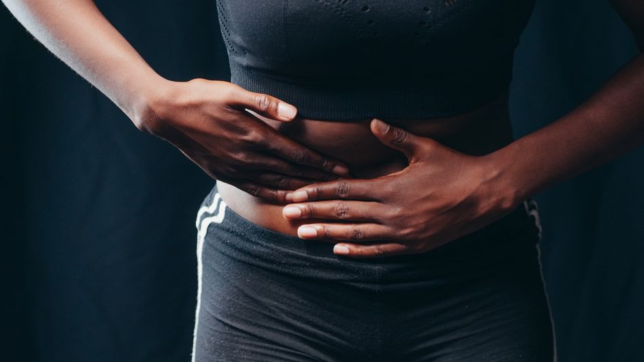 Close-up of an ultrasound showing a fetus on a monitor in a medical clinic.