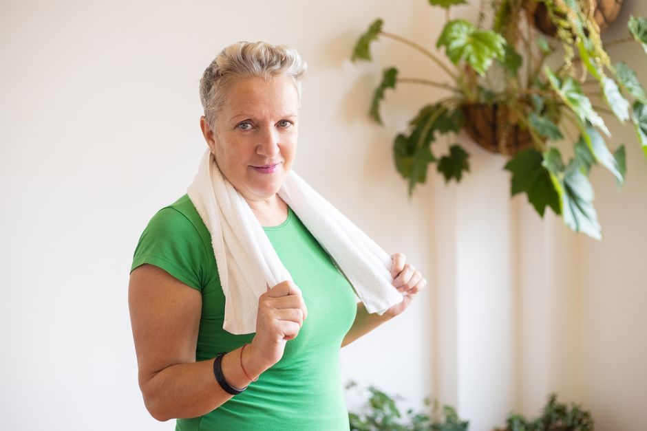Close-up portrait of a contemplative middle-aged woman indoors.