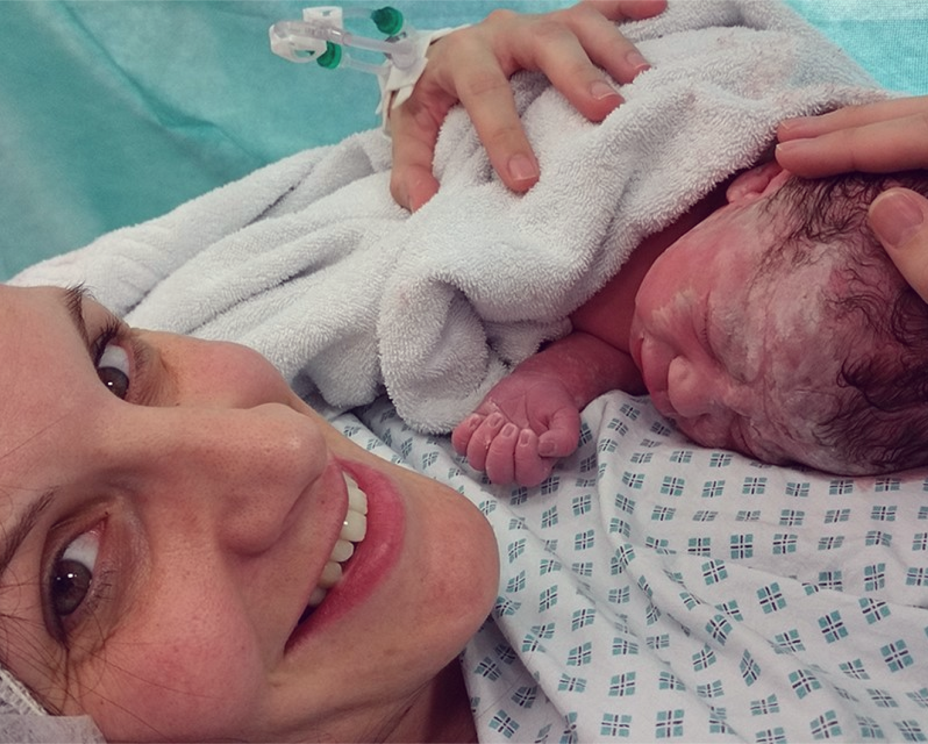 Alison, a patient of Mr Broome, holding her baby
